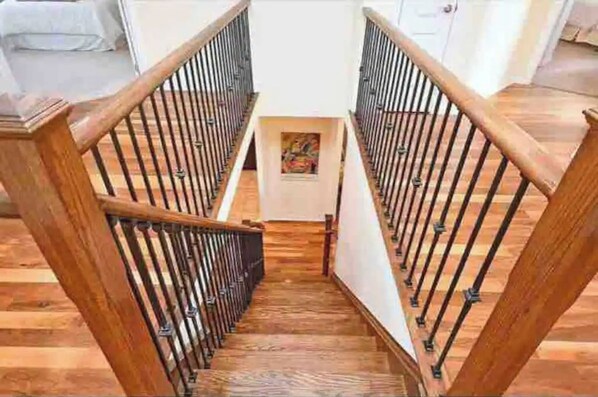 Staircase leads to an upper floor, flanked by walls and a door.