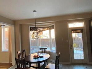 Enjoy meals with family and friends in this dining area with a round table and four chairs.