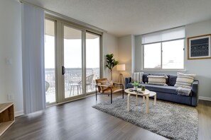 City Apartment | Living area | 38-inch Smart TV with cable channels, TV, computer monitors