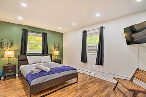 Relax in a spacious room with a large bed, flat-screen TV, and comfortable seating area.