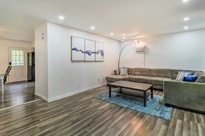 Relax in this stylish living room with a leather sofa, coffee table, and abstract art.