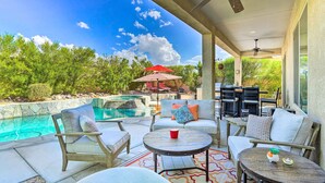 A covered outdoor patio with a pool, seating area, and ceiling fans. - Indio Home w/ Private Pool & Community Amenities (Indio)