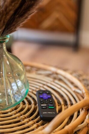 A remote control on a woven basket.