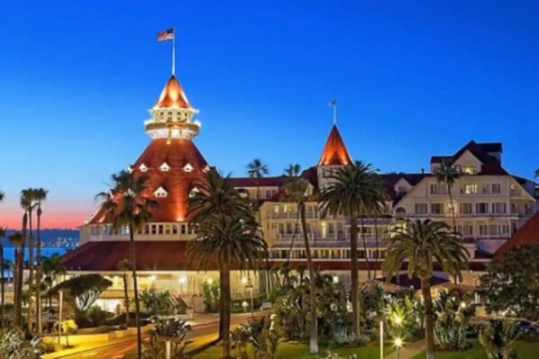 A large, multi-story hotel with a prominent tower and a flag on top.