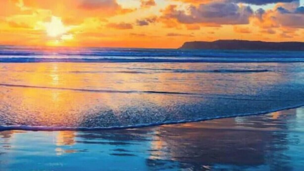 A beach with a sunset, calm water, and a distant landmass. - Unit C - B Ave Bungalows · Surf Shack Studio, 5 Min Walk to Coronado Beach! (Coronado)