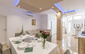 Enjoy meals in this stylish dining area with a table set for a meal.