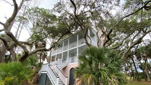 A two-story building with a central staircase and a balcony on the upper floor. - Marsa's Place-Marsh/Creek/Ocean Views; Easy Beach Access;Dogs Welcome (Edisto Island)