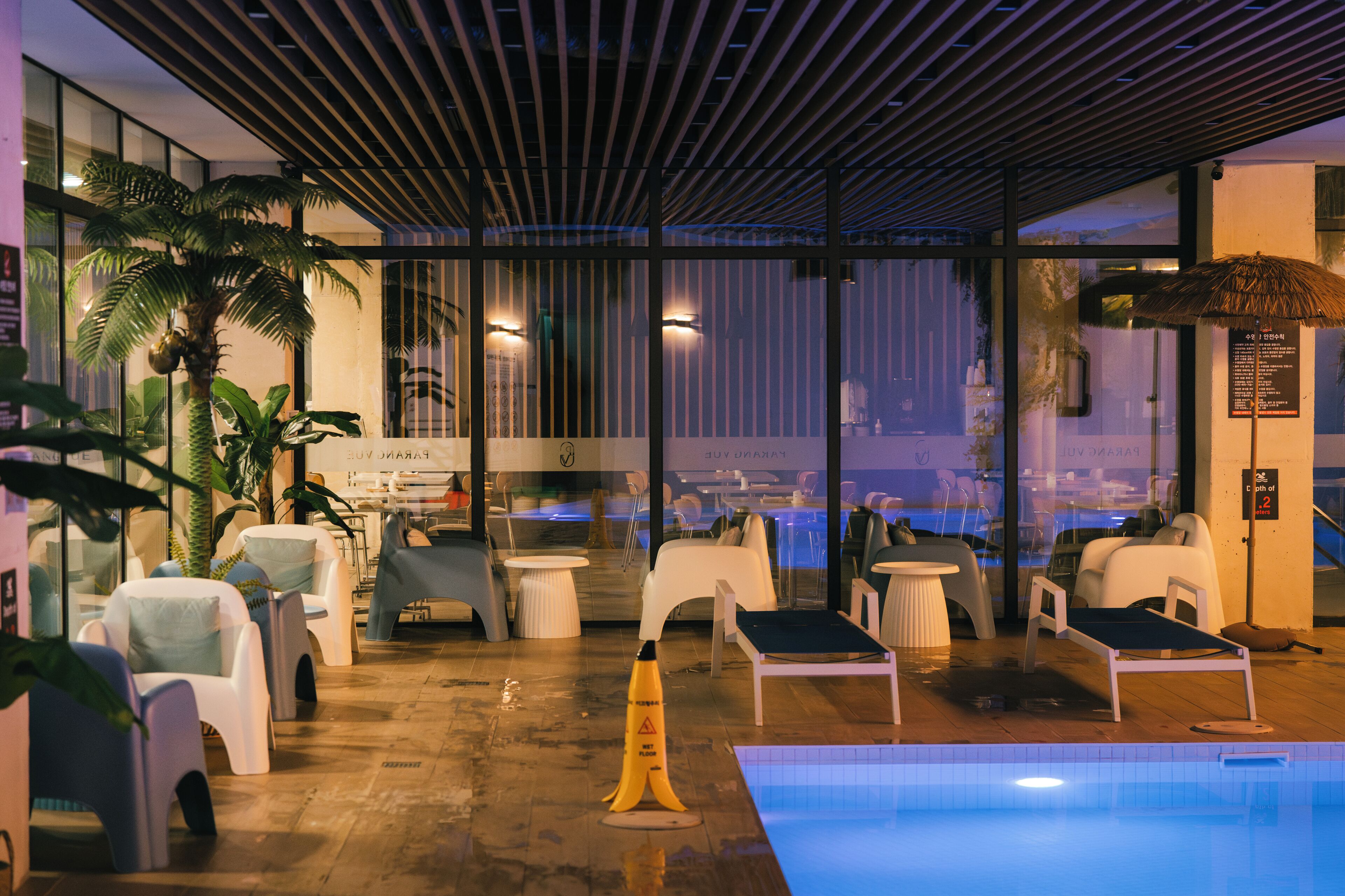 A poolside area with lounge chairs, a small pool, and a view of the cityscape.