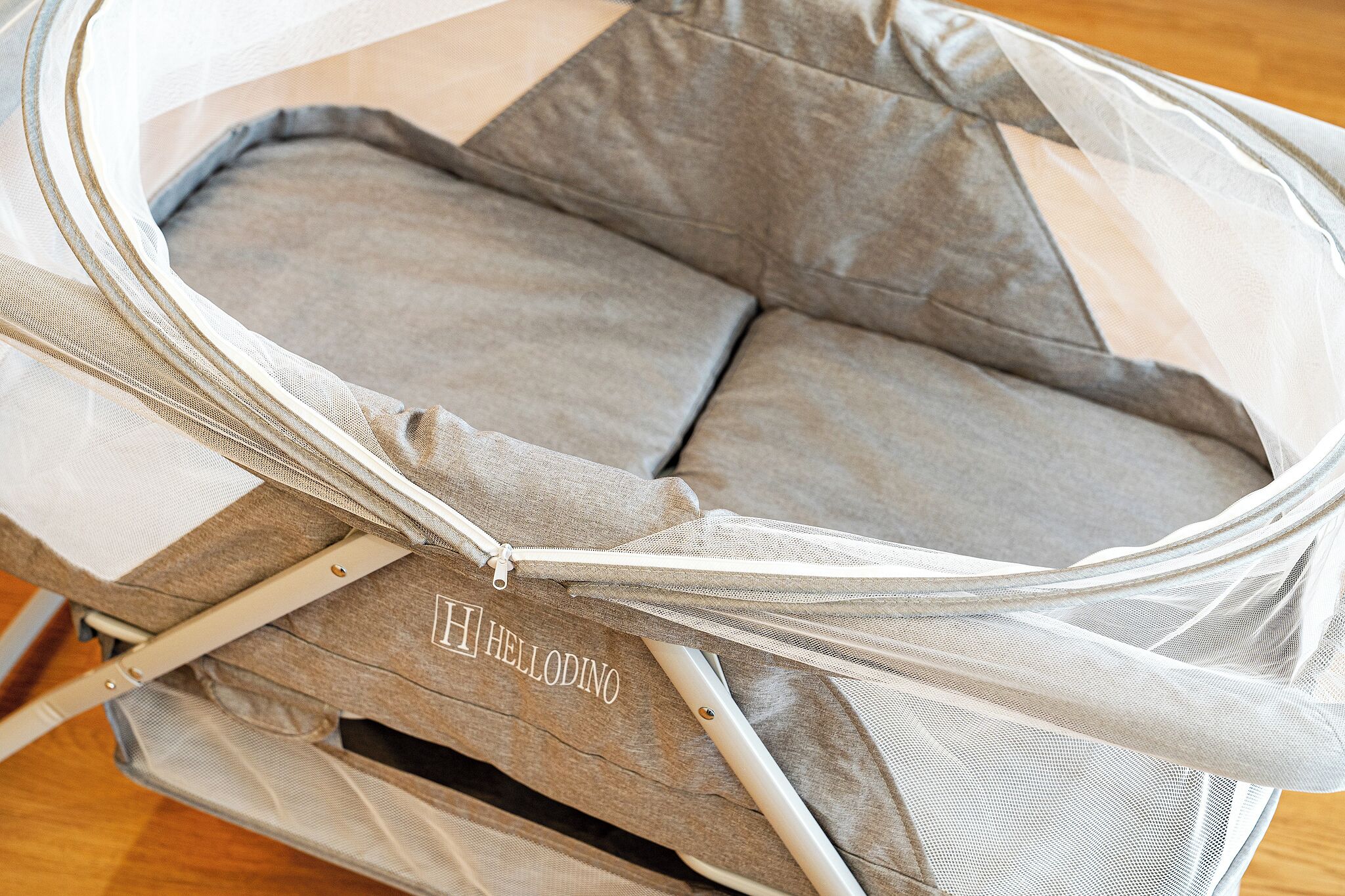 A baby stroller with a mesh canopy and a grey fabric seat.