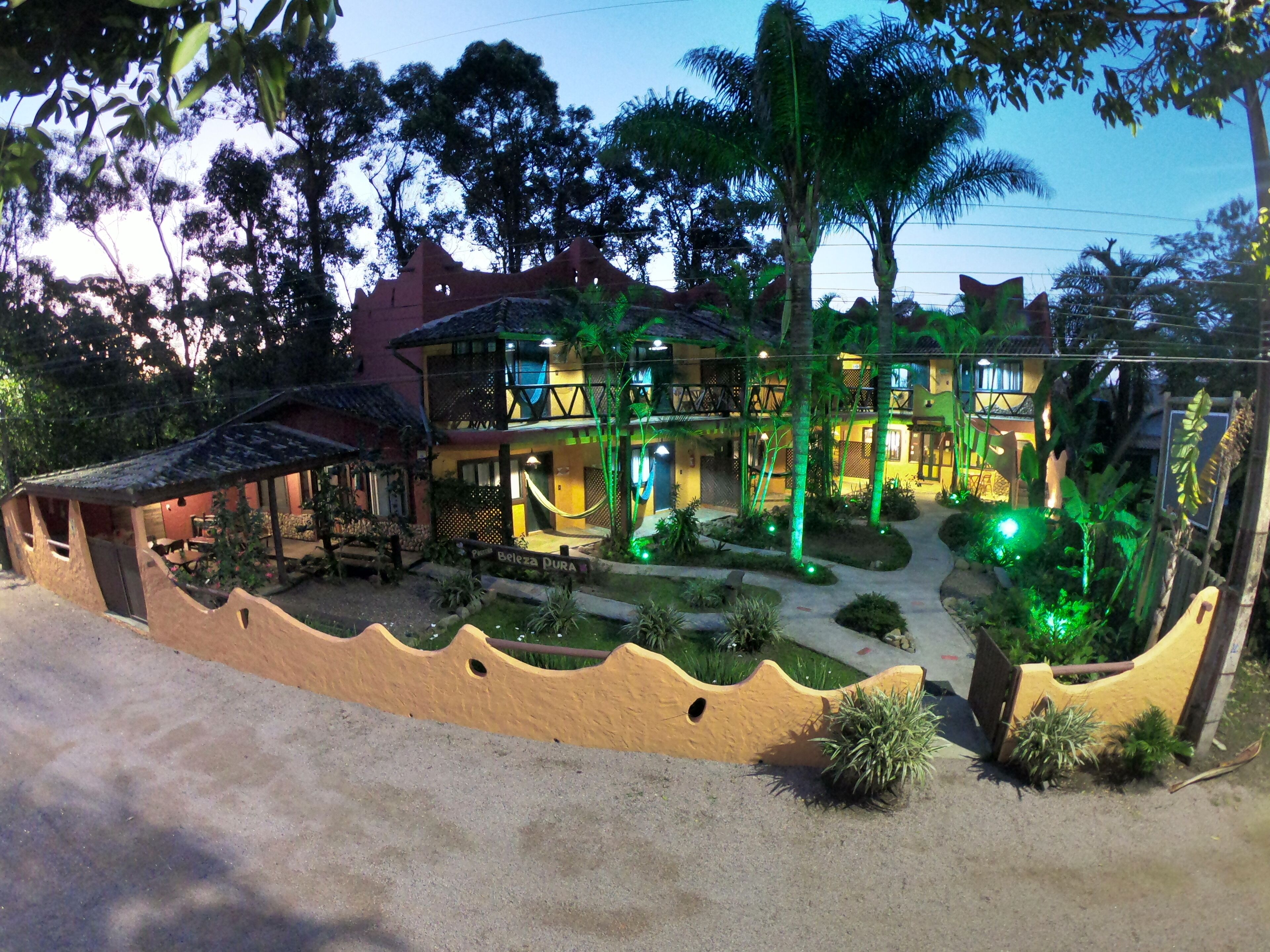A two-story building with a balcony and a covered seating area.