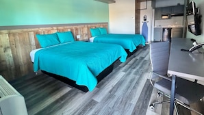 A hotel room with two beds, a kitchenette, and a bathroom. - The Residency Suites (Sugar Land)
