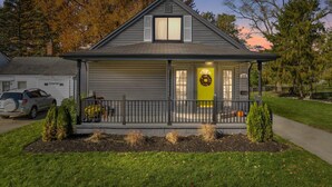 A single-story house with a front porch, a garage, and a driveway. - Modern Zen Farmhouse to help you recharge and rejuvenated (Royal Oak)