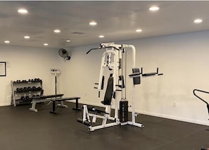 A gym with weightlifting equipment, a bench, and a rack of dumbbells. - 2 Bed, 2.5 Bath Lake Murray Townhouse Loaded With Amenities! (La Mesa)