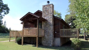 A log cabin with a stone chimney, wooden deck, and a stone foundation. - Stones Throw from Giant City Park, Wineries, Hiking, Biking, Hunting and more. (Makanda)
