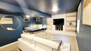 A modern living room with a sofa, a bed, a coffee table, and a fireplace. - $0 Fees-Hot Tub, Lake View Oasis-Near Shops/Dining (Arvada)