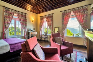 A room with two single beds, a wooden ceiling, and a view of greenery through the windows. - Sterling Park Kalimpong (Kalimpong)