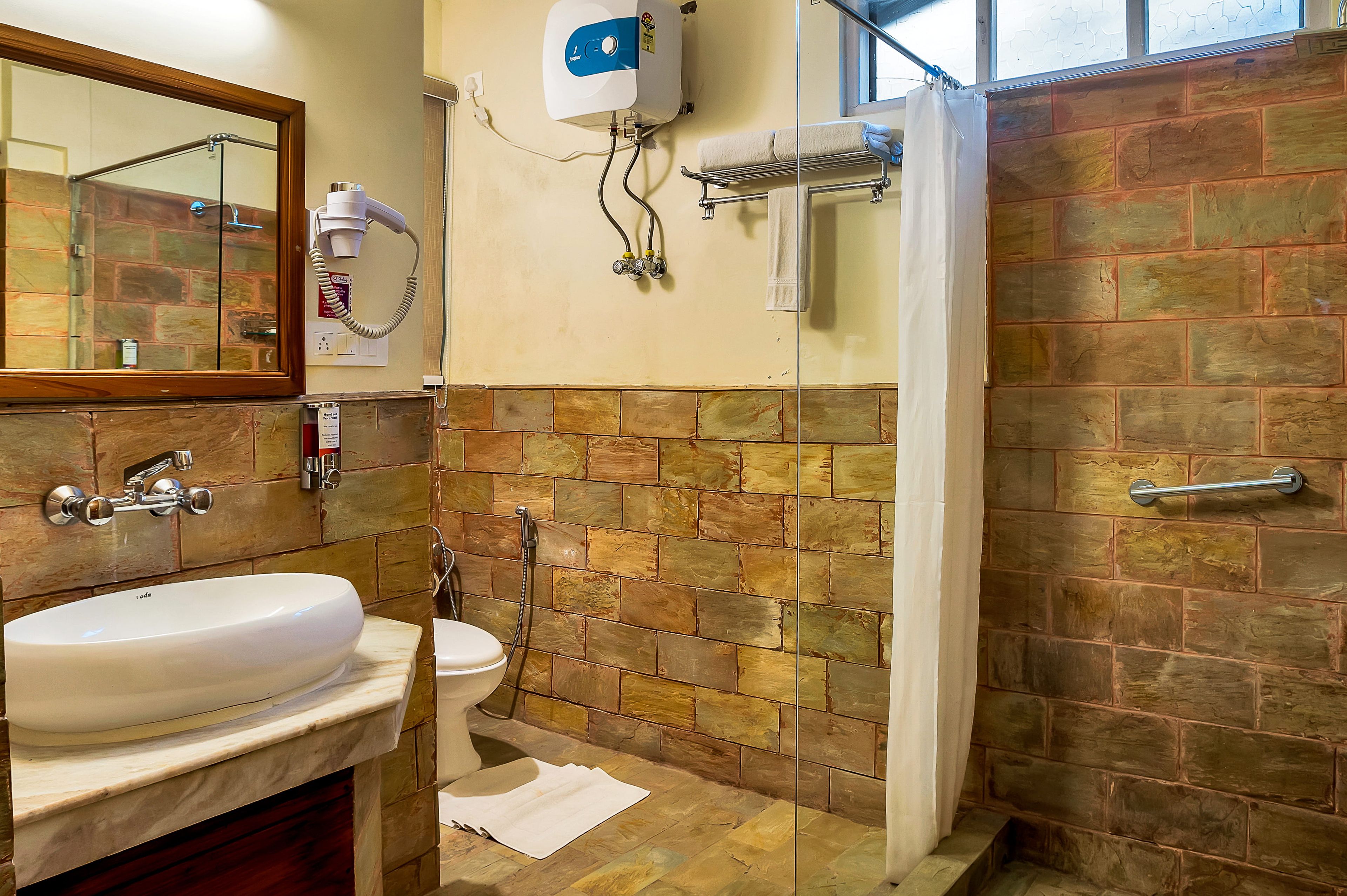 A bathroom with a sink, toilet, and shower.