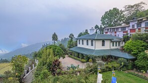 A traditional building with a green roof, surrounded by lush greenery and a mountainous backdrop. - Sterling Park Kalimpong (Kalimpong)