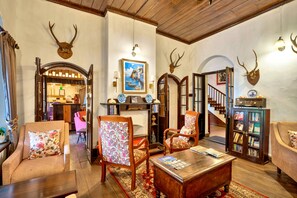 A traditional interior with wooden furniture, a fireplace, and antler decorations. - Sterling Park Kalimpong (Kalimpong)