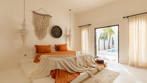 A bedroom with a bed, a large window, and a view of a pool. - Villa Ores Bali (Canggu)