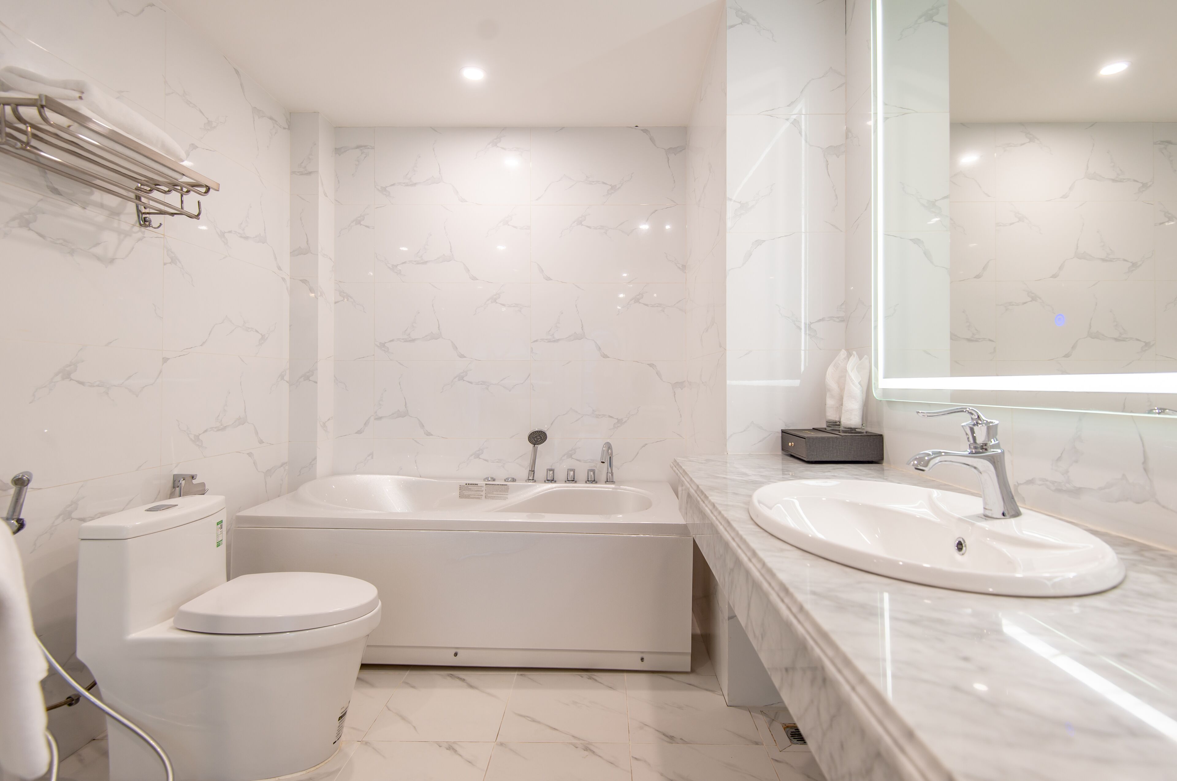 A modern bathroom with a bathtub, toilet, and sink.