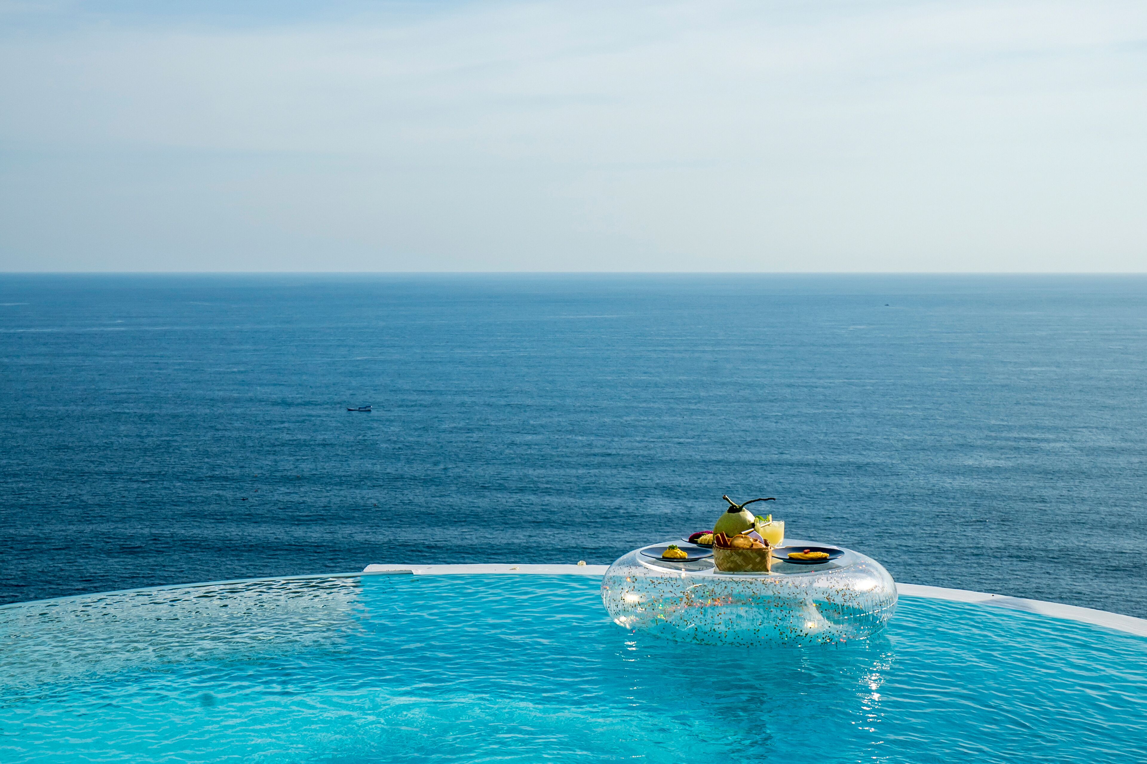 A pool with a clear view of the ocean.