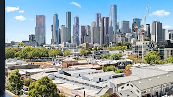 A cityscape with modern high-rise buildings and a mix of older industrial buildings.