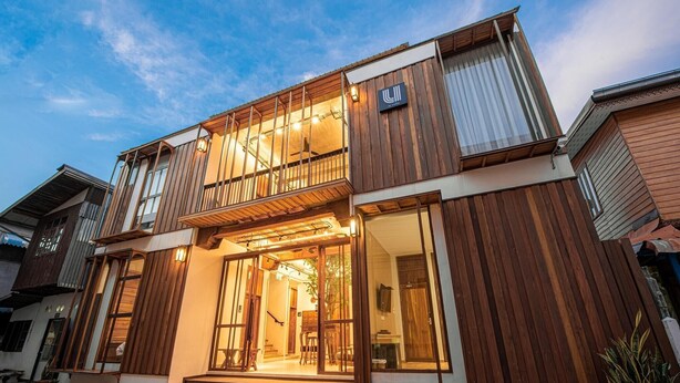 A modern two-story building with large windows and a balcony. - U Chaikhong (Chiang Khan)