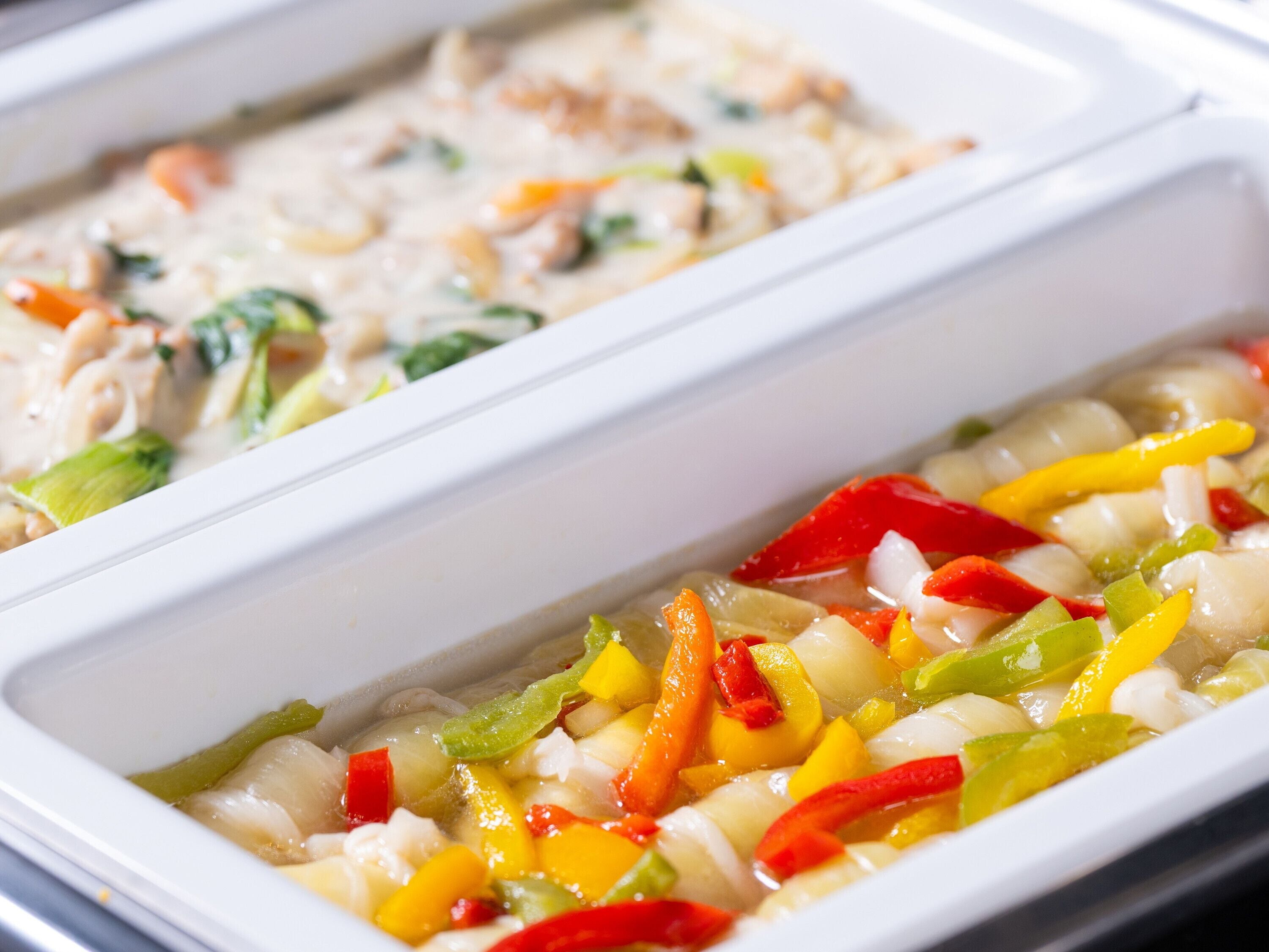 A white rectangular dish containing a seafood and vegetable mixture.