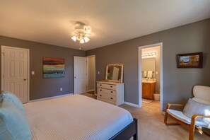 A bedroom with a bed, dresser, chair, and a ceiling fan. - Petes Alpine Retreat - pet friendly Seven Devils home close to ziplining, snow tubing (Seven Devils)