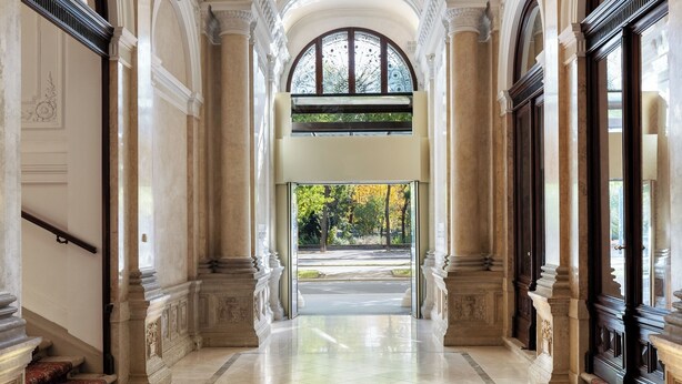 An ornate hallway with high ceilings, arched doorways, and a central window. - Almanac Palais Vienna (Vienna)