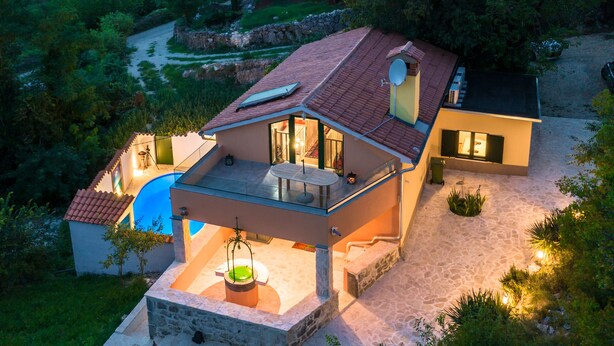 A two-story house with a swimming pool, a covered patio, and a stone pathway. - A rustic stone house with pool and sea views. (Ripenda Kosi)