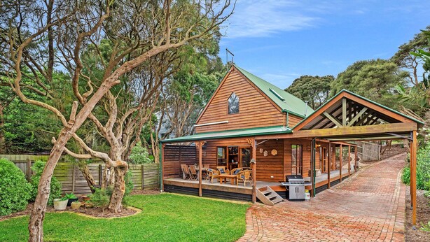 A wooden cabin with a green roof, a covered patio, and a brick pathway leading to the entrance. - Stunning holiday home that has you feeling like you are in a Swiss chalet (Blairgowrie)