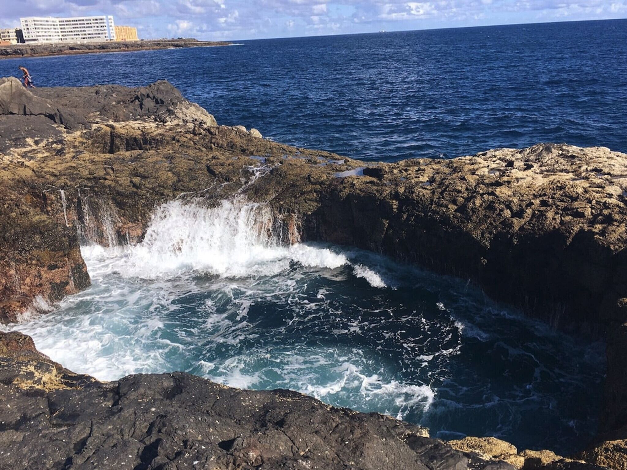 A rocky coastline with waves crashing against the rocks.