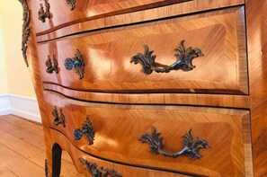 A wooden dresser with ornate metal handles and a curved design. - Inviting 3-bed Villa Apartment in Bad Kreuznach (Bad Kreuznach)