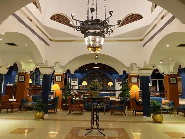 A lobby with a chandelier, seating area, and a reception desk. - Aida Hotel Sharm El Sheikh (Sharm El Sheikh)