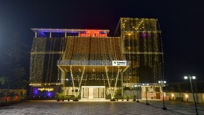 Un edificio con un letrero que dice "WINSOME BANQUET & RESORT" y el logotipo de "treelbo trend".
