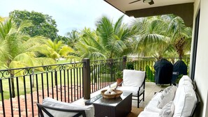A balcony with wicker furniture, a wicker basket, and two Weber BBQ grills. - Exclusive golf course view apartment in Buenaventura Golf & (El Chirú)