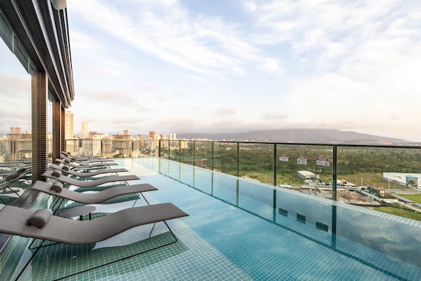 Outdoor pool, open 10:00 AM to 10:00 PM, pool loungers