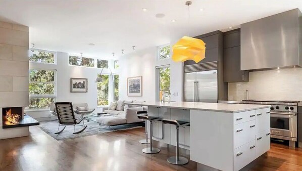 Enjoy cooking in this well-equipped kitchen with a central island, bar stools, and oven.