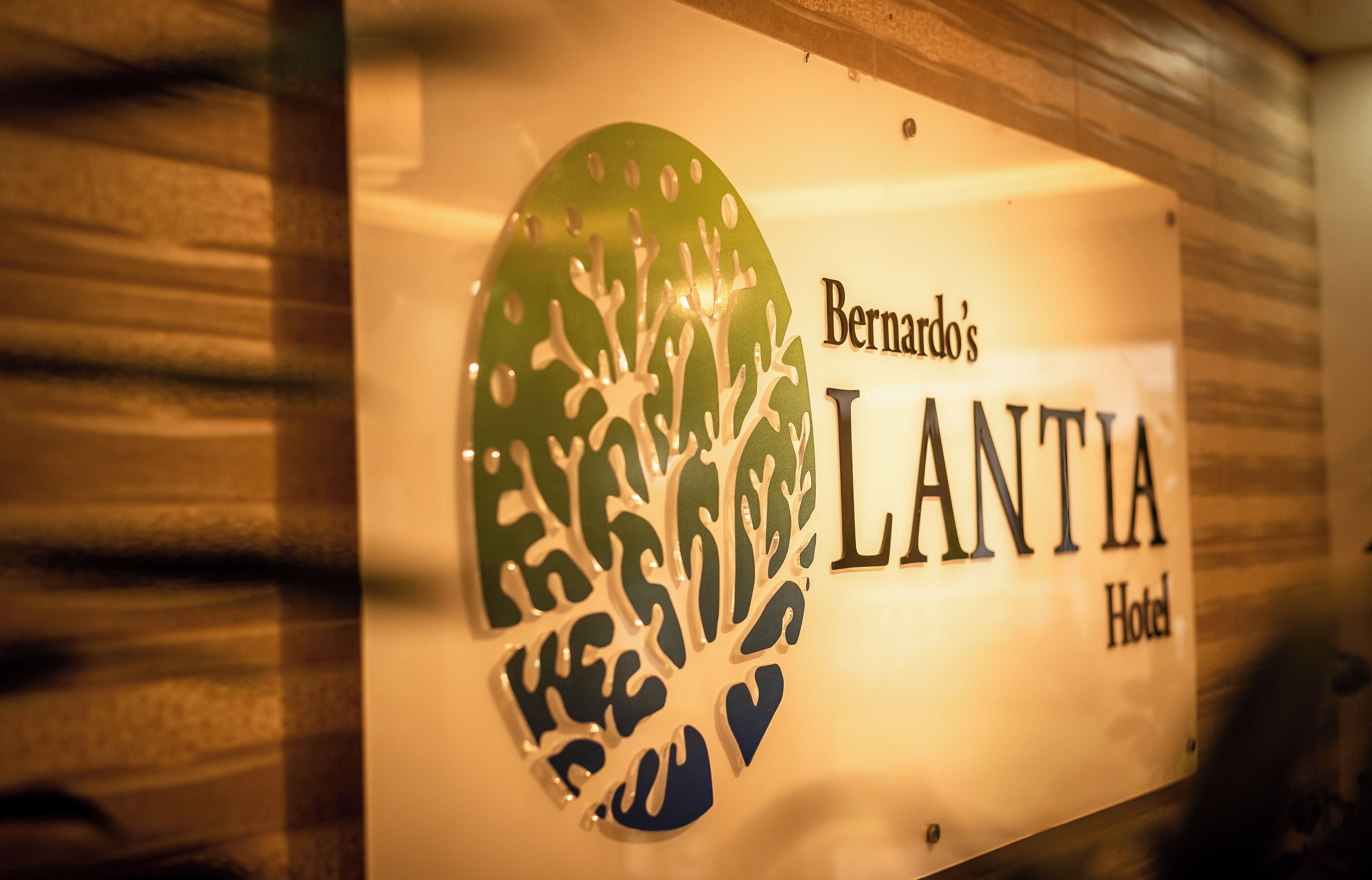 A hotel sign with a tree design and the name "Bernardo's LANTIA Hotel".
