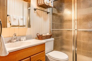 Bathroom features a sink, mirror, and glass shower enclosure.