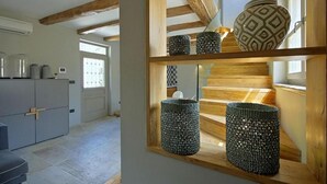 A staircase with wooden railings and decorative baskets. - Luxuriously decorated villa with designer interior, pool, sauna and wellness (Pićan)