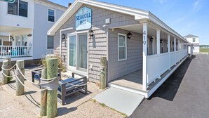 A Seagull Inn with a covered porch, a small outdoor seating area, and a visible entrance. - * *Oceanfront | Hampton Beach | Pet Friendly* * (Hampton)