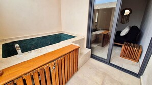 A modern bathroom with a glass shower enclosure, a wooden bench, and a tiled floor. - Smart Depas Tulum (Tulum)