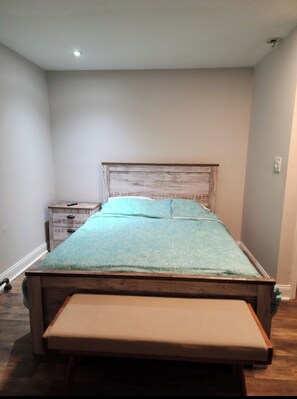 Cozy retreat with a single bed, wooden headboard, and a nightstand.