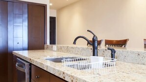 A kitchen with a granite countertop, a double sink, and a modern faucet. - CONDO Q BY TRVL2HM (Cabo San Lucas)