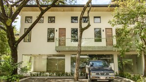 A modern two-story house with a car parked in the driveway. - Perfectly located in Playa Guiones. Walk to the beach, shops, restaurants & yoga (Nosara)