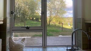 A bathroom with a large window, a white ceramic rooster, and a modern faucet. - ★ Private & Peaceful | 5 mins to Donegal Town ★ (Donegal Town)