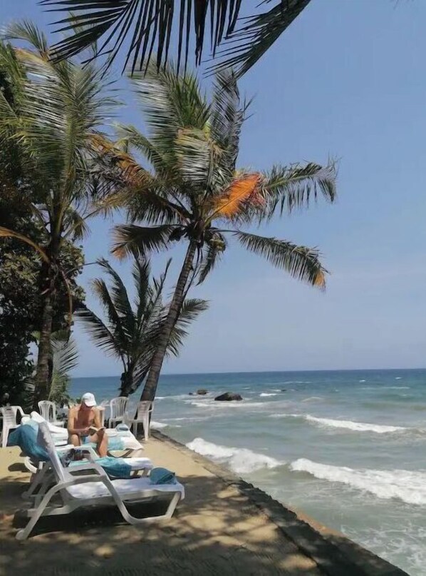 Relax on the beach with a view of the ocean from our lounge chairs.